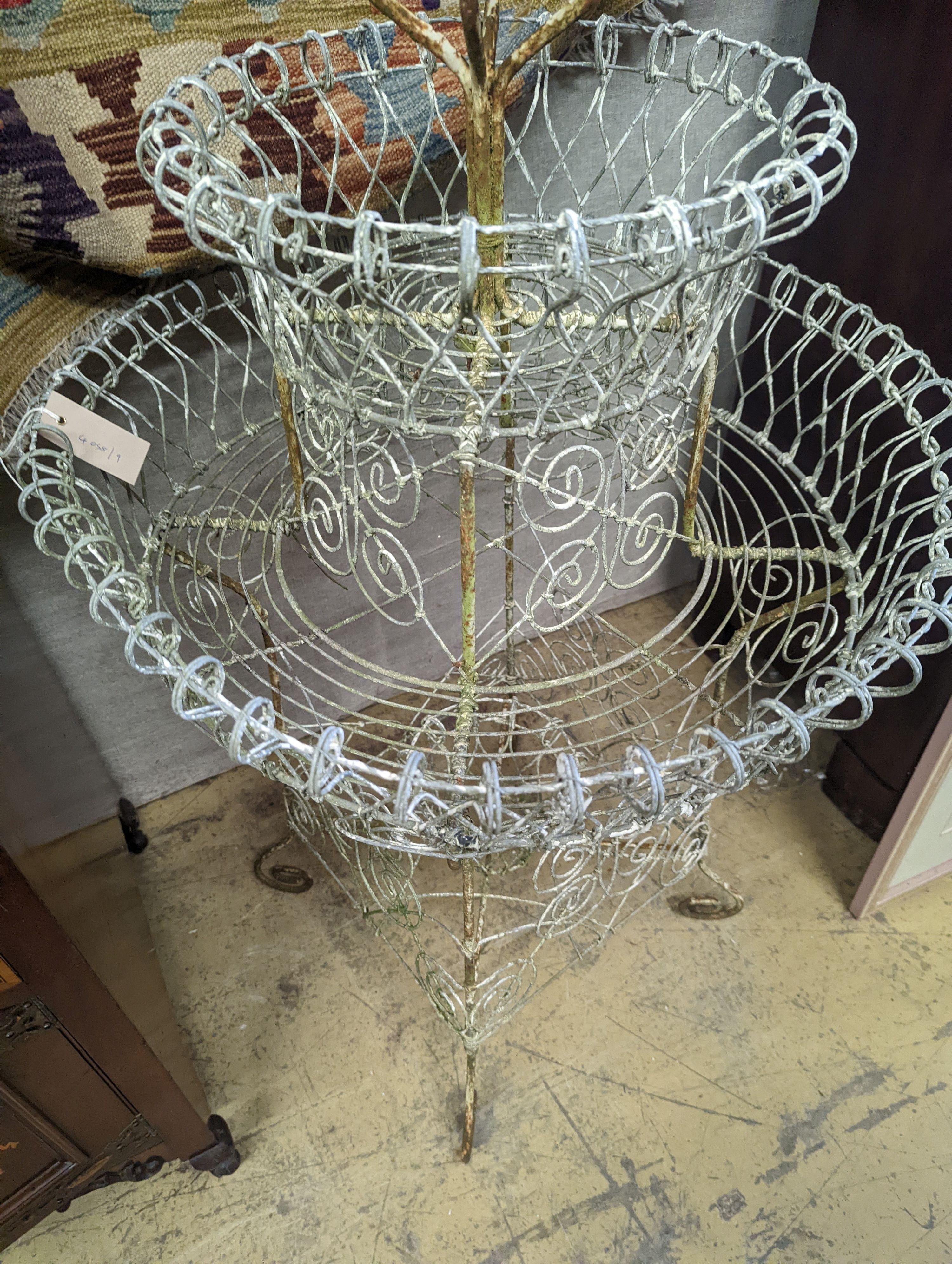 A Victorian painted wirework three tiered plant stand, diameter 65cm, height 112cm